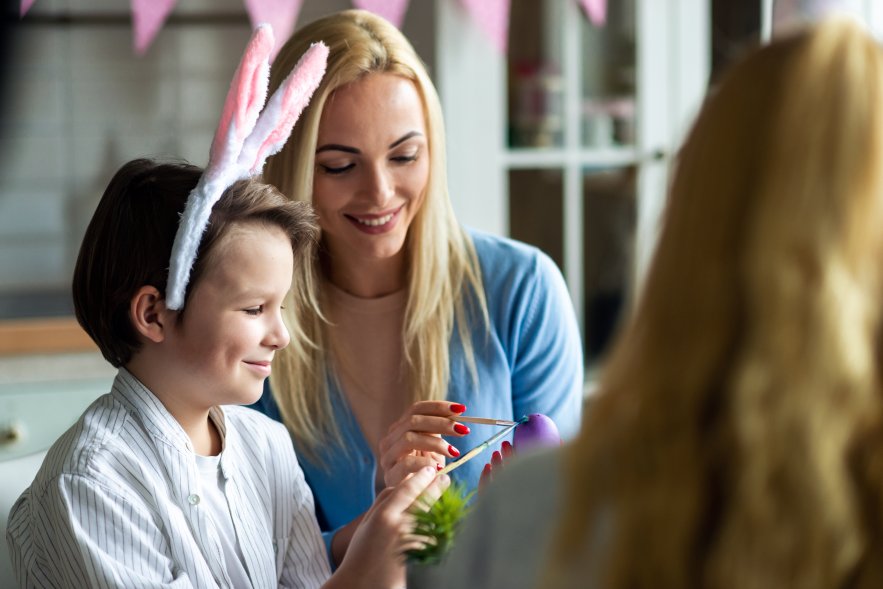 The Mother Helps Her Children Paint Easter Eggs